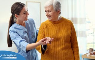 A caregiver helps a client get around, demonstrating one of the job duties of a caregiver.