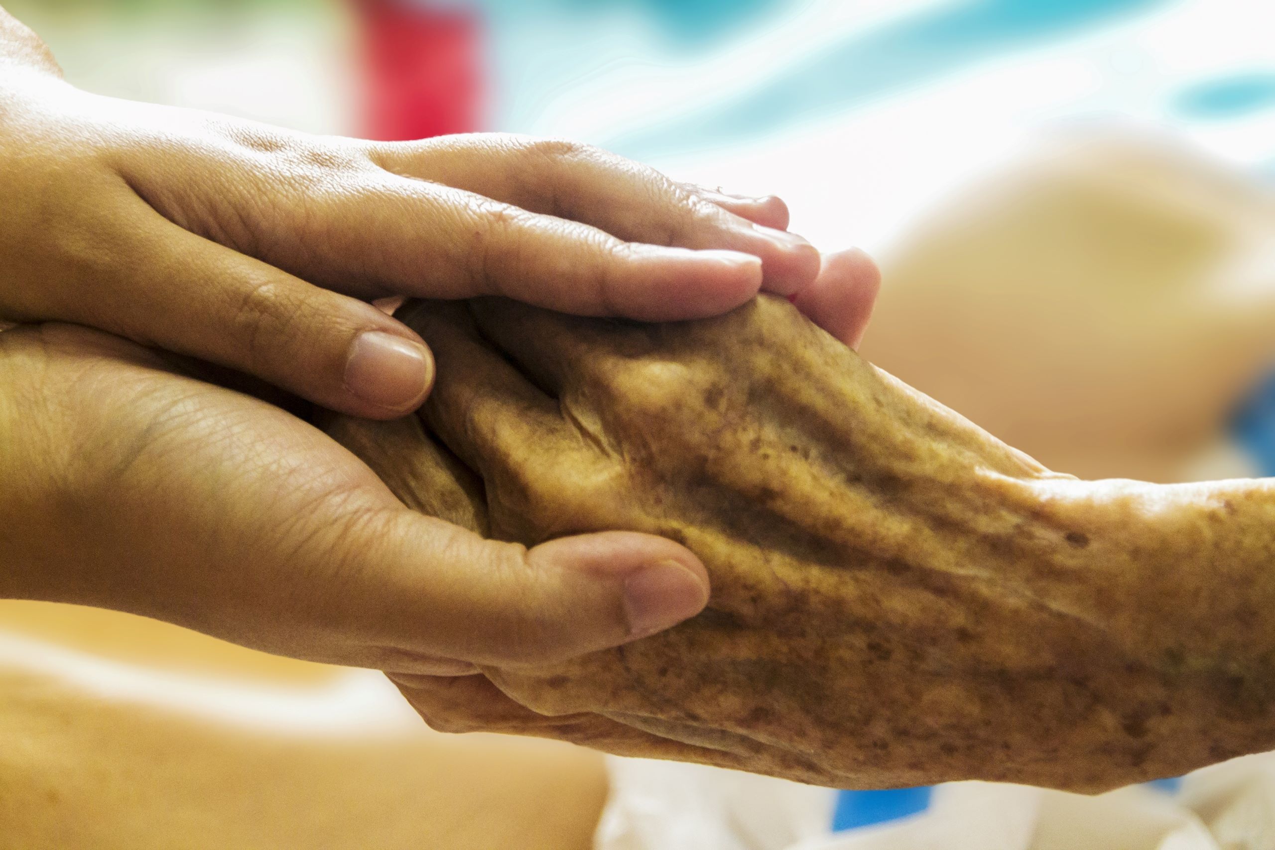 This image shows a compassionate caregiver gently holding the hand of an elderly patient. The gesture symbolizes comfort, empathy, and support during a difficult time. It represents the essence of hospice care in Waltham, where patients receive dignified and compassionate end-of-life care