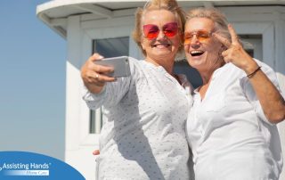 2 smiling and joyful seniors travelling outdoors and taking a selfie