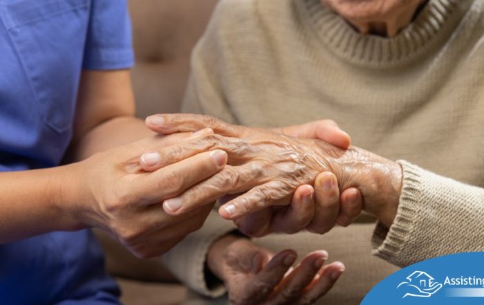 A care provider examines an older adult’s fingers, representing what would happen in an examination for rheumatoid arthritis.