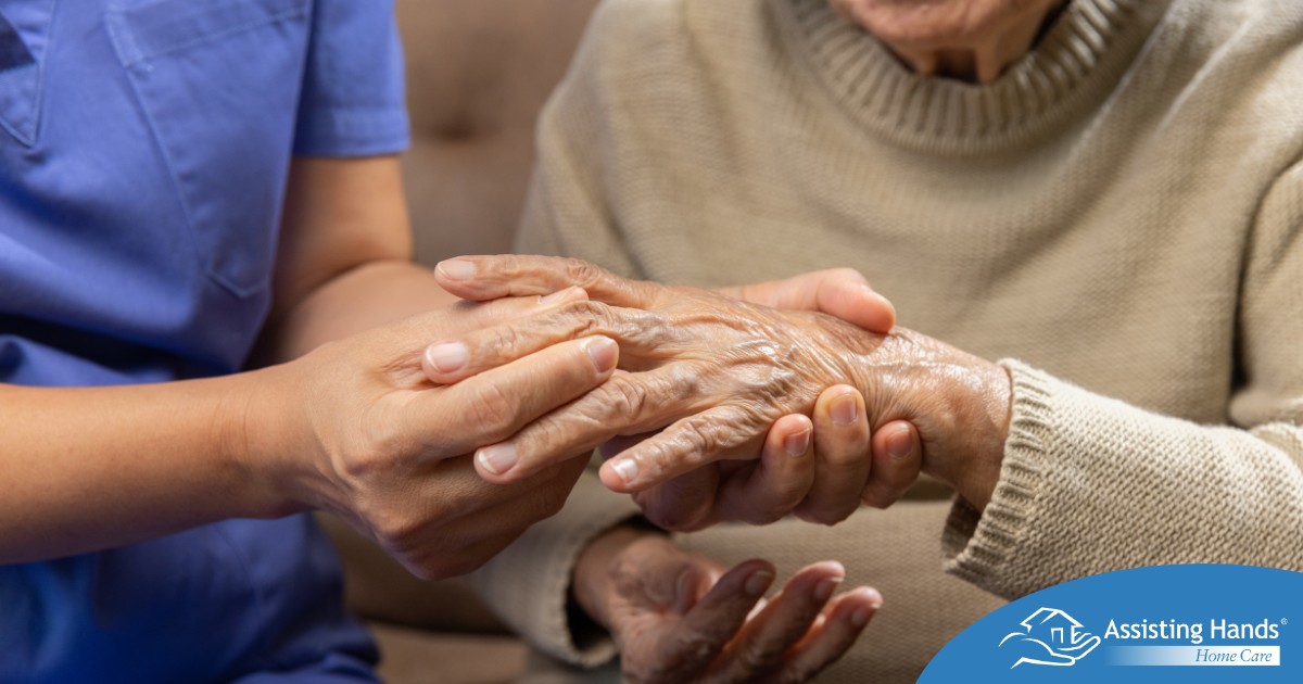 A care provider examines an older adult’s fingers, representing what would happen in an examination for rheumatoid arthritis.