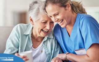 A woman in scrubs laughs with a senior woman, representing how caregiving can be a great career choice.