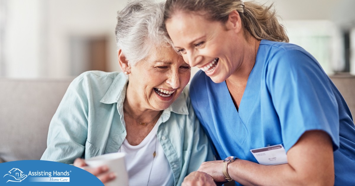 A woman in scrubs laughs with a senior woman, representing how caregiving can be a great career choice.