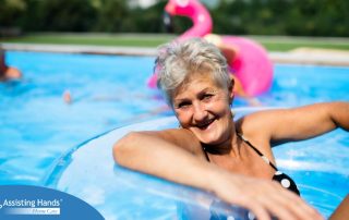 Senior woman in swimming pool outdoors in backyard enjoying summer.