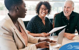 A couple talks with and advisor, representing the type of preparation that is crucial for successful senior care planning.