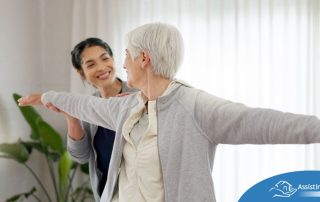 A caregiver and senior practice tai chi as one of many enriching activities for seniors at home.