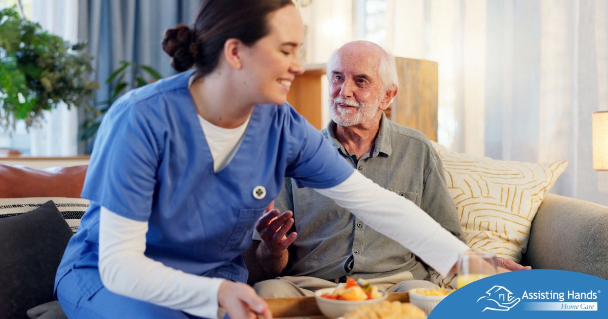 Caregiver providing senior care at home to manage parkinson’s and related symptoms.