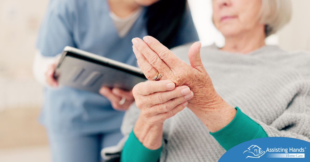 A caregiver provides in home care services to a senior with arthritis