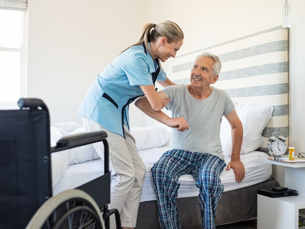 Caregiver assisting a senior man with mobility as part of Fall Prevention services in Lexington