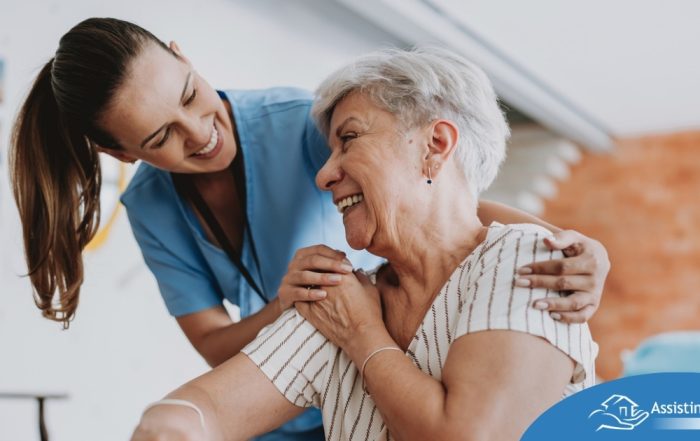 A female caregiver helping an older woman with stroke recovery at home.