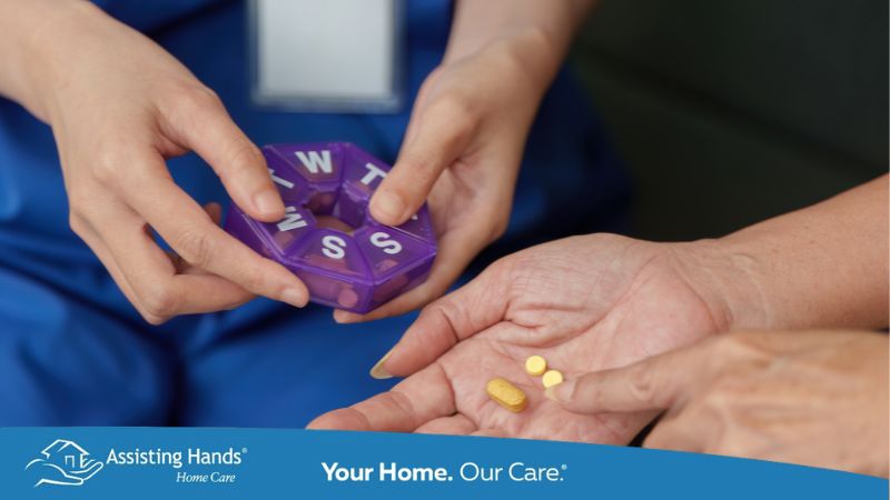 Caregiver assisting elderly patient with medication management Caregiver assisting elderly patient with medication management