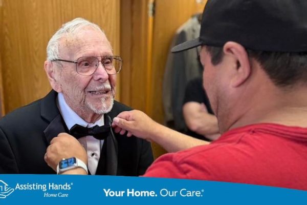 Ray Svejnoha, age 100, smiles as community members at Independence Village help him get ready for prom