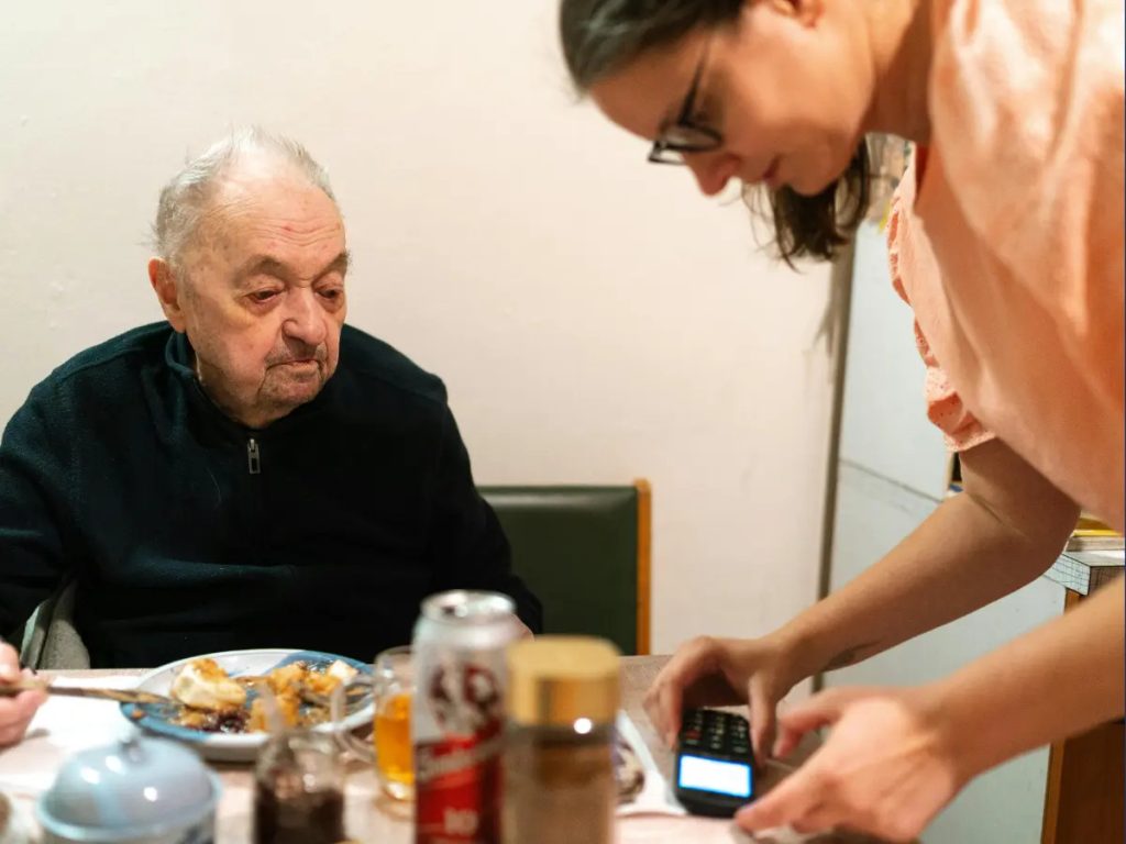 caregiver help senior serving food