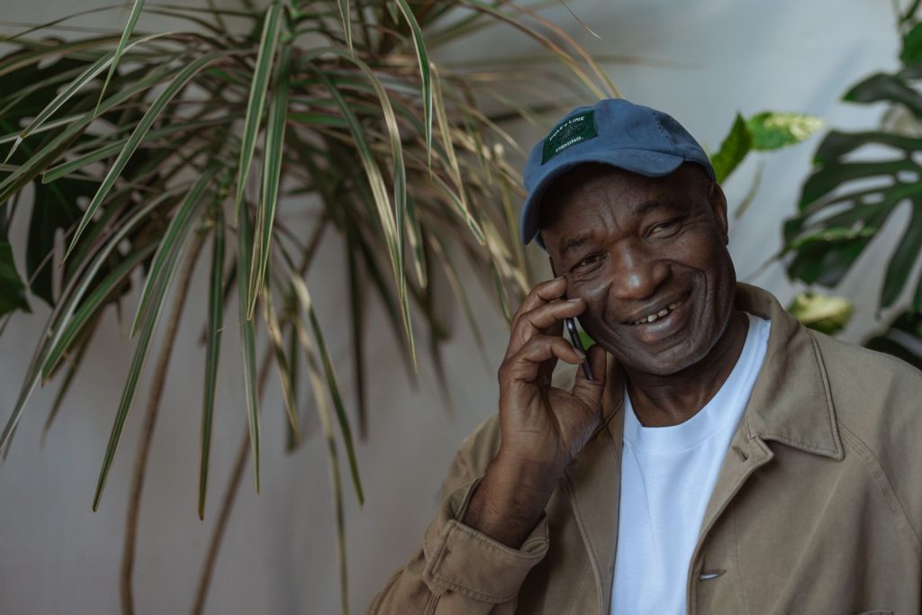Smiling senior man talking on the phone during a check-in call with family