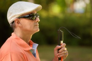 Portrait Of Blind Man Sitting In City Park