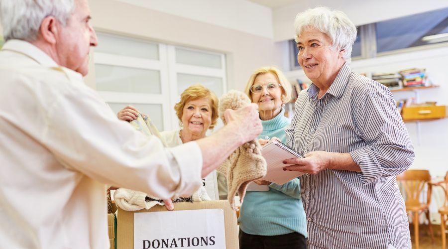 senior man donating his old items to clean the clutter
