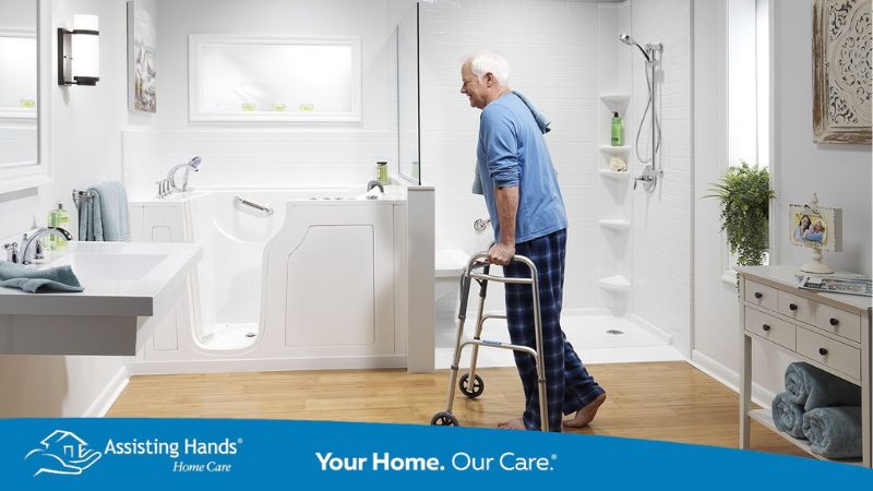 Seniors stepping into a walk-in tub for safety in the bathroom