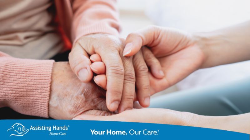 caregiver holding the hand of elderly woman who has weak grip strength