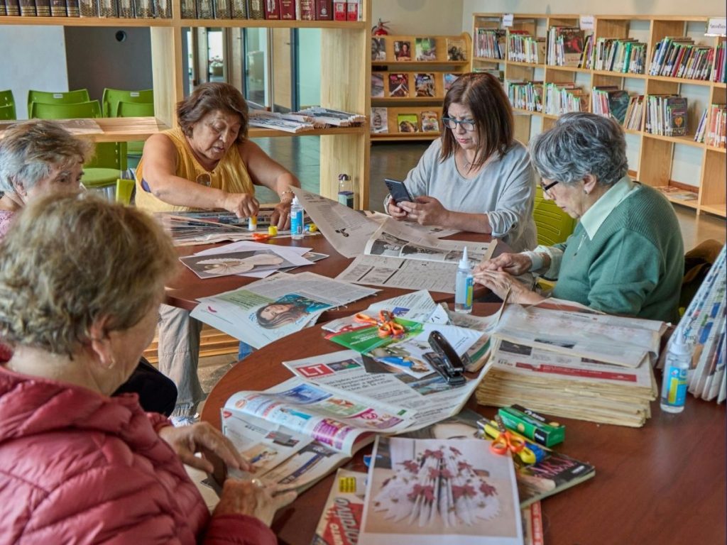seniors sitting on table and playing games