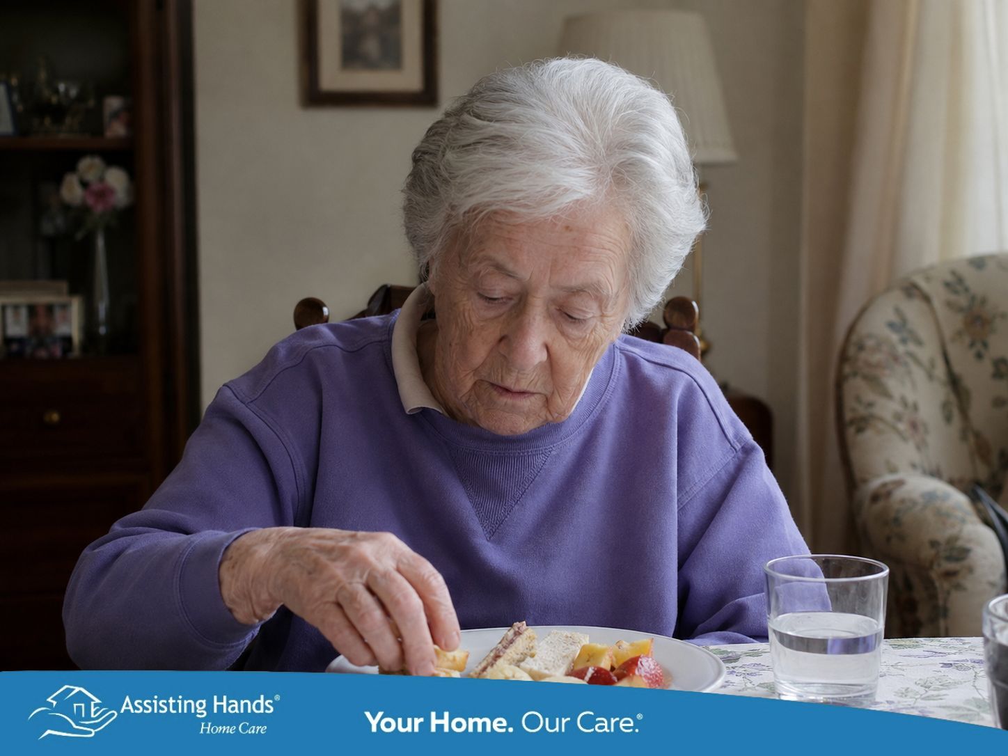 Elderly woman with dementia eating finger foods at her dining table at home. Elderly woman with dementia eating finger foods at her dining table at home.