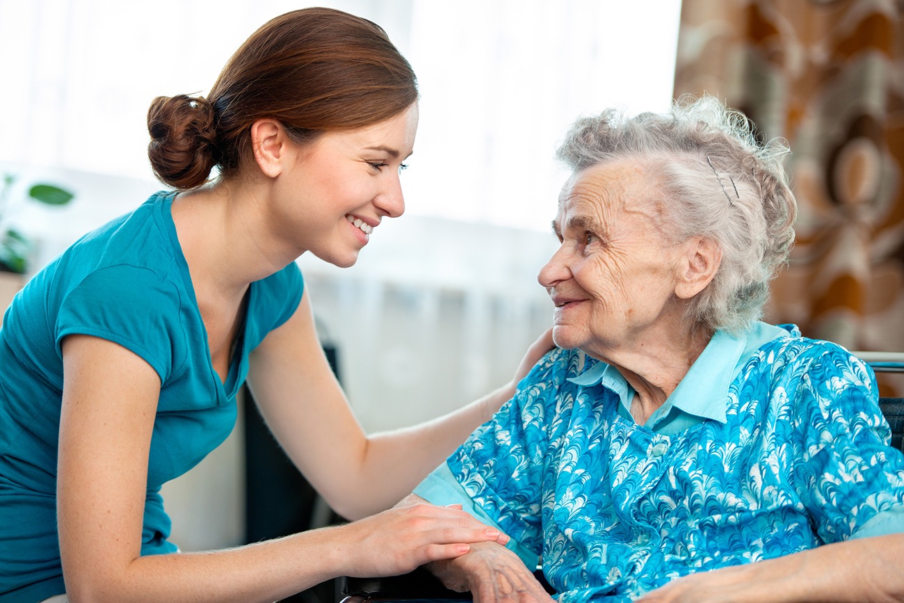 An in-home caregiver helps an elderly woman feel appreciated.