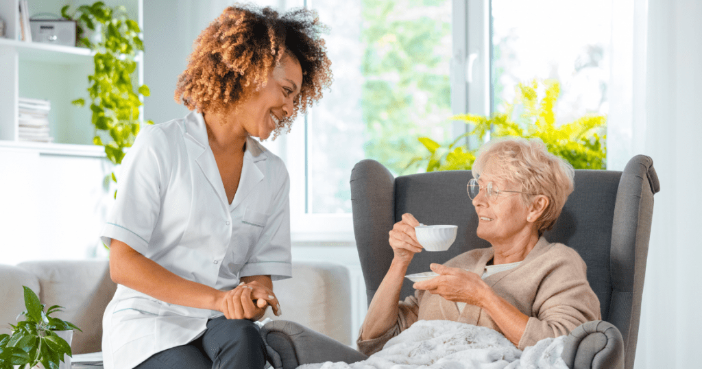 Nurse-sitting-with-elderly-nurses-week