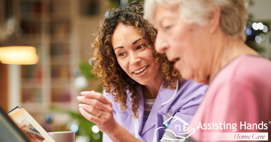 Senior woman with dementia and caregiver looking at a family album together