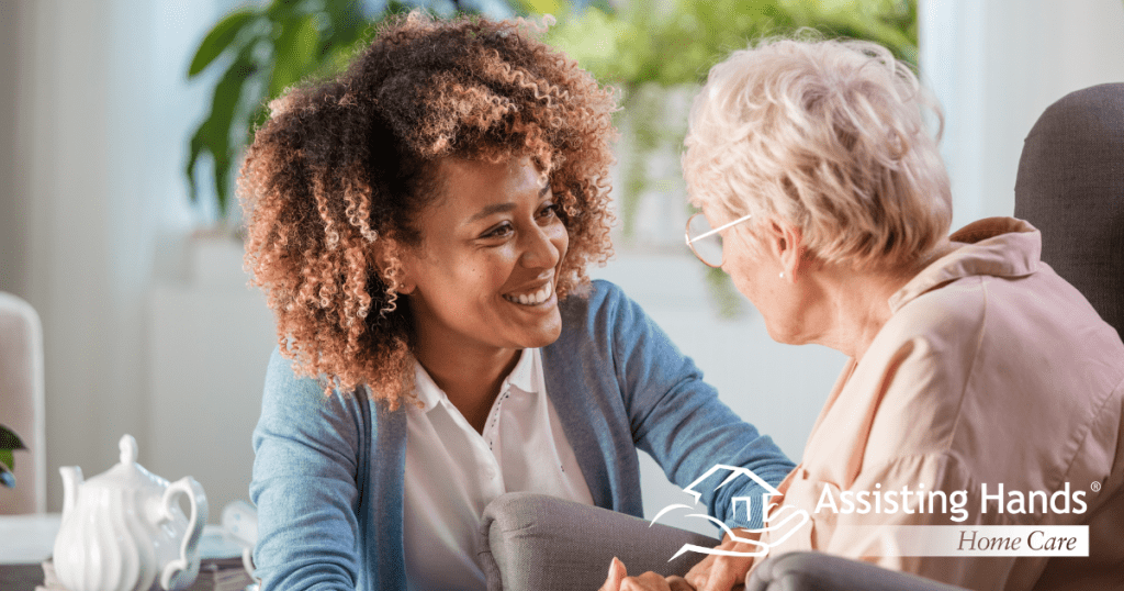 A woman enjoys compassionately providing caregiving services to an elderly woman.