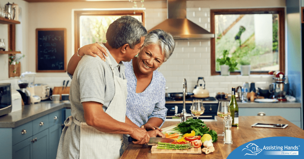 A senior couple enjoys cooking a healthy meal together, representing National Nutrition Month.