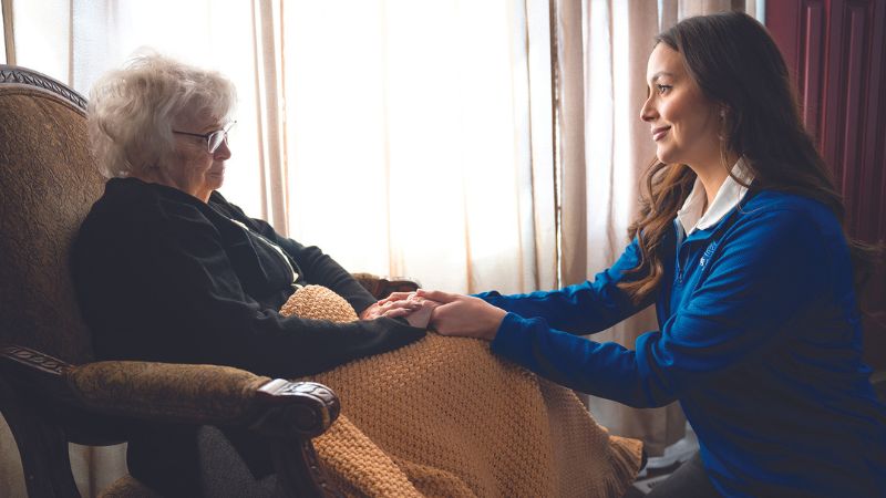 caregiver offering emotional support to an elderly person experiencing hallucinations