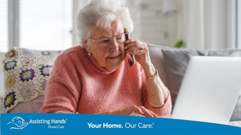 Senior woman using a laptop at home, engaged in online activity