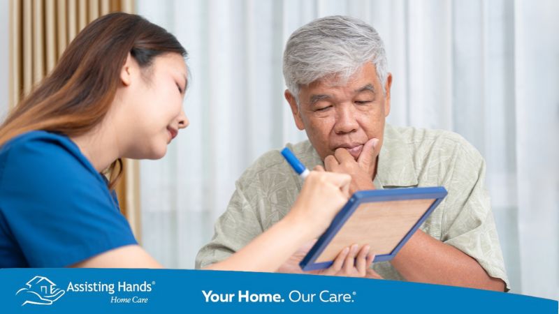 Assisting Hands Westlake Ohio Caregiver sharing meal plans with diabetic senior man Assisting Hands Westlake Ohio Caregiver sharing meal plans with diabetic senior man