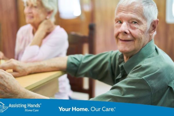 Senior with Dementia Sits at the Table and Plays Dominoes who is at stage 2 of dementia