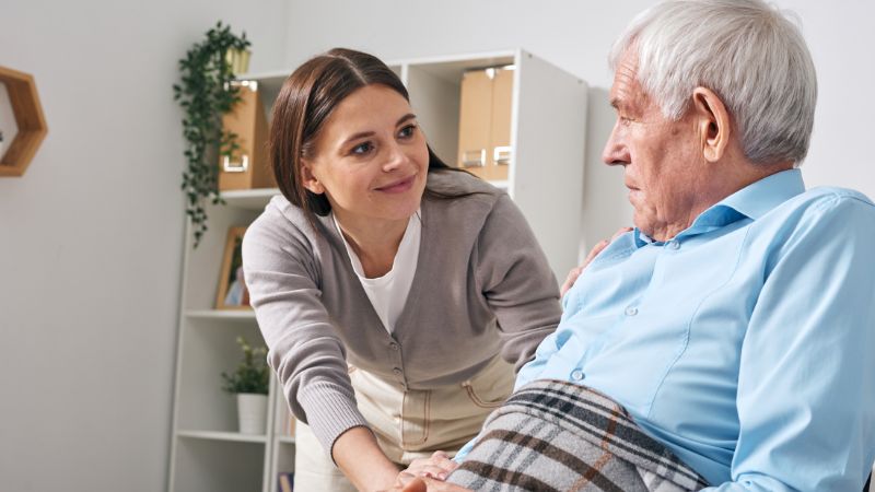 family caregiver with her senior dad at home taking care family caregiver with her senior dad at home taking care